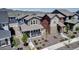 Inviting two-story home with a cozy front porch and well-manicured landscaping, set against a scenic mountain backdrop at 8049 Monte Vista Cir, Littleton, CO 80125