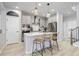 Modern kitchen with stainless steel appliances, a large island, and stylish pendant lighting at 8049 Monte Vista Cir, Littleton, CO 80125