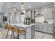 Bright kitchen with stainless appliances, white countertops, island seating and grey cabinetry at 8049 Monte Vista Cir, Littleton, CO 80125