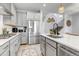 Modern kitchen with gray cabinetry, stainless steel appliances, and a center island at 8049 Monte Vista Cir, Littleton, CO 80125