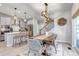 Open-concept living space with modern decor, a cozy dining area, and a stylish kitchen at 8049 Monte Vista Cir, Littleton, CO 80125