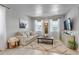 Bright, neutral living area with a soft rug, large windows and a comfortable couch at 8049 Monte Vista Cir, Littleton, CO 80125