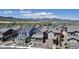 Picturesque view of a residential neighborhood with well-maintained homes and lush landscaping, framed by majestic mountains at 8049 Monte Vista Cir, Littleton, CO 80125