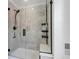 Modern shower with glass enclosure, tiled walls, and sleek black fixtures at 8049 Monte Vista Cir, Littleton, CO 80125
