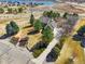 Aerial view of a home featuring mature trees, a pond view, a spacious yard, and a welcoming driveway at 2174 Meadow Vale Rd, Longmont, CO 80504