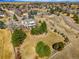 Stunning aerial view of home and large lot with mature trees in established community at 2174 Meadow Vale Rd, Longmont, CO 80504