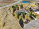 Aerial view of a property with a large yard, mature trees, and a pond nearby at 2174 Meadow Vale Rd, Longmont, CO 80504