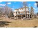 Spacious backyard featuring a two-story home with a large deck and patio area perfect for outdoor entertaining at 2174 Meadow Vale Rd, Longmont, CO 80504