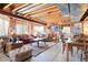 Basement living room with exposed ceiling, large windows, and rustic furniture at 2174 Meadow Vale Rd, Longmont, CO 80504