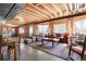 Inviting basement living room with a cozy seating area, exposed beams, and natural light at 2174 Meadow Vale Rd, Longmont, CO 80504