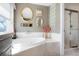 Bright bathroom features a large soaking tub and separate glass shower at 2174 Meadow Vale Rd, Longmont, CO 80504
