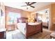 Bright bedroom with a large window, a wooden bed frame, and mirrored closet doors at 2174 Meadow Vale Rd, Longmont, CO 80504