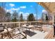Spacious deck ideal for outdoor dining and relaxation with beautiful views of the surrounding trees at 2174 Meadow Vale Rd, Longmont, CO 80504