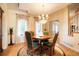 Formal dining room with chandelier and large windows with decorative curtains at 2174 Meadow Vale Rd, Longmont, CO 80504