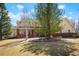 Beautiful two-story home with a welcoming front porch, manicured lawn, and mature trees enhancing curb appeal at 2174 Meadow Vale Rd, Longmont, CO 80504