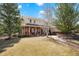 Well-maintained two-story home featuring a brick facade, inviting front porch, and lush landscaping at 2174 Meadow Vale Rd, Longmont, CO 80504