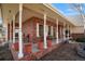 Charming brick porch with white columns, decorative planters, and ample space for seating at 2174 Meadow Vale Rd, Longmont, CO 80504