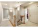 Upstairs hallway featuring wood banister and several entrances to bedrooms at 2174 Meadow Vale Rd, Longmont, CO 80504