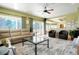 Bright living room with large windows and modern decor with view to kitchen at 2174 Meadow Vale Rd, Longmont, CO 80504