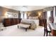 Comfortable main bedroom with hardwood floors, fan, and large windows at 2174 Meadow Vale Rd, Longmont, CO 80504