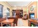 Home office featuring wooden desk and shelving, fireplace, and natural light at 2174 Meadow Vale Rd, Longmont, CO 80504