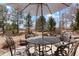 Inviting outdoor patio with elegant metal furniture and shade umbrella, perfect for enjoying the serene backyard setting at 2174 Meadow Vale Rd, Longmont, CO 80504