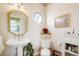 Cozy powder room featuring pedestal sink, octagon window and decorative mirror at 2174 Meadow Vale Rd, Longmont, CO 80504