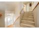 Carpeted staircase and entryway leading to the front door at 2174 Meadow Vale Rd, Longmont, CO 80504