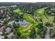 Panoramic aerial view of a golf course community with lush green fairways, tranquil ponds, and luxury homes at 3201 Country Club Pkwy, Castle Rock, CO 80108