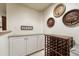 Close-up of bar area with storage, a countertop, and decorative barrel-themed wall art at 3201 Country Club Pkwy, Castle Rock, CO 80108