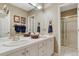 Bright bathroom featuring double sinks, white cabinets, and a separate shower area at 3201 Country Club Pkwy, Castle Rock, CO 80108
