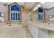 A well-appointed bathroom offers double vanity, soaking tub and separate glass shower at 3201 Country Club Pkwy, Castle Rock, CO 80108