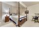 Cozy bedroom with a four-poster bed, matching nightstand, and a peaceful ambiance at 3201 Country Club Pkwy, Castle Rock, CO 80108