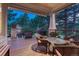 This covered patio with wicker seating and a grill provides ample space for outdoor relaxation and dining at 3201 Country Club Pkwy, Castle Rock, CO 80108