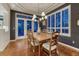 Dining room with hardwood floors, a chandelier, and large windows providing ample natural light and an outdoor view at 3201 Country Club Pkwy, Castle Rock, CO 80108
