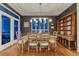 Elegant dining room featuring hardwood floors, large windows, stylish lighting, and classic furnishings at 3201 Country Club Pkwy, Castle Rock, CO 80108