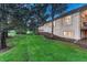 Exterior shot of the house showing lawn and landscaping including trimmed bushes and fresh mulch at 3201 Country Club Pkwy, Castle Rock, CO 80108
