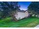 Exterior view of the house showing its architectural details and well-manicured lawn, set amidst mature trees at 3201 Country Club Pkwy, Castle Rock, CO 80108