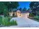 Inviting home features a well-maintained lawn and driveway, with mature trees offering shade at 3201 Country Club Pkwy, Castle Rock, CO 80108