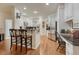 Spacious kitchen area with bar seating, stainless steel appliances, hardwood floors, and ample counter space at 3201 Country Club Pkwy, Castle Rock, CO 80108