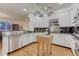 Bright kitchen features white cabinets, stainless steel appliances and hardwood floors at 3201 Country Club Pkwy, Castle Rock, CO 80108