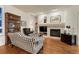 Comfortable living room featuring a fireplace, hardwood floors, built-in bookshelves, and a patterned sofa at 3201 Country Club Pkwy, Castle Rock, CO 80108