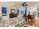 A stunning main bedroom boasts a four-poster bed, fireplace, and an abundance of natural light at 3201 Country Club Pkwy, Castle Rock, CO 80108