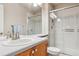 Bathroom with vanity, large mirror, and walk-in shower featuring glass doors at 6237 Trailhead Rd, Highlands Ranch, CO 80130