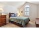 Cozy bedroom featuring a window with arched top, neutral paint, carpet and comfortable-looking bed at 6237 Trailhead Rd, Highlands Ranch, CO 80130