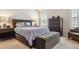 Bedroom with a comfy, upholstered bed, a chest and an ottoman at 6237 Trailhead Rd, Highlands Ranch, CO 80130