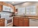 Well-lit kitchen boasts modern appliances and granite countertops, creating a functional and stylish space at 6237 Trailhead Rd, Highlands Ranch, CO 80130