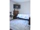 A cozy bedroom featuring a patterned bedspread, dresser, television, and a decorative rug at 650 S Clinton St # 2A, Denver, CO 80247