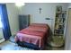 Simple bedroom with a bed, shelving, and hardwood floors at 650 S Clinton St # 2A, Denver, CO 80247