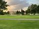 Scenic golf course view featuring a pond with fountains and lush green landscaping at 650 S Clinton St # 2A, Denver, CO 80247
